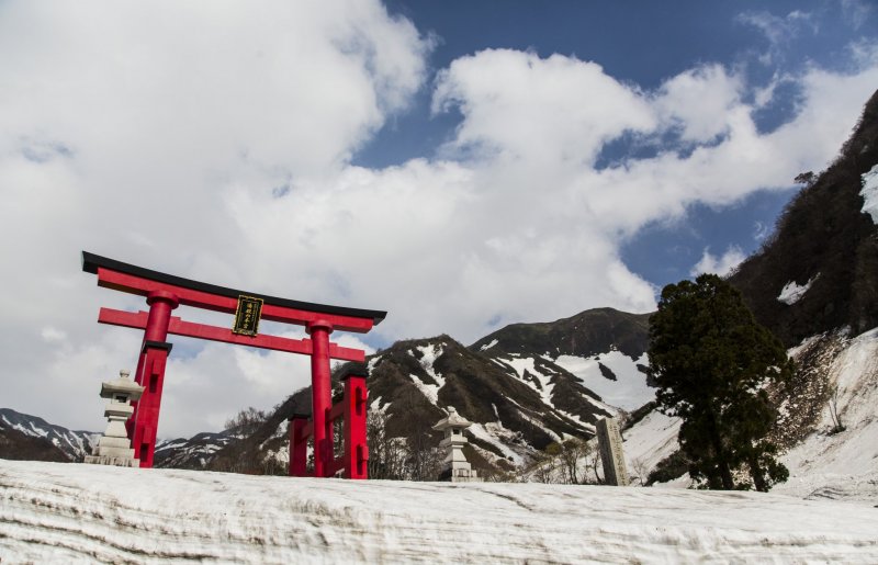 Torii gate at snowy mountains of Akita, Japan. Article about Japanese New Year's customs from remote snowy Akita - Namahage. Dark Namahage presence in New Year's day, their history, mythology behind it and role in modern Japan, manga, anime and video games.