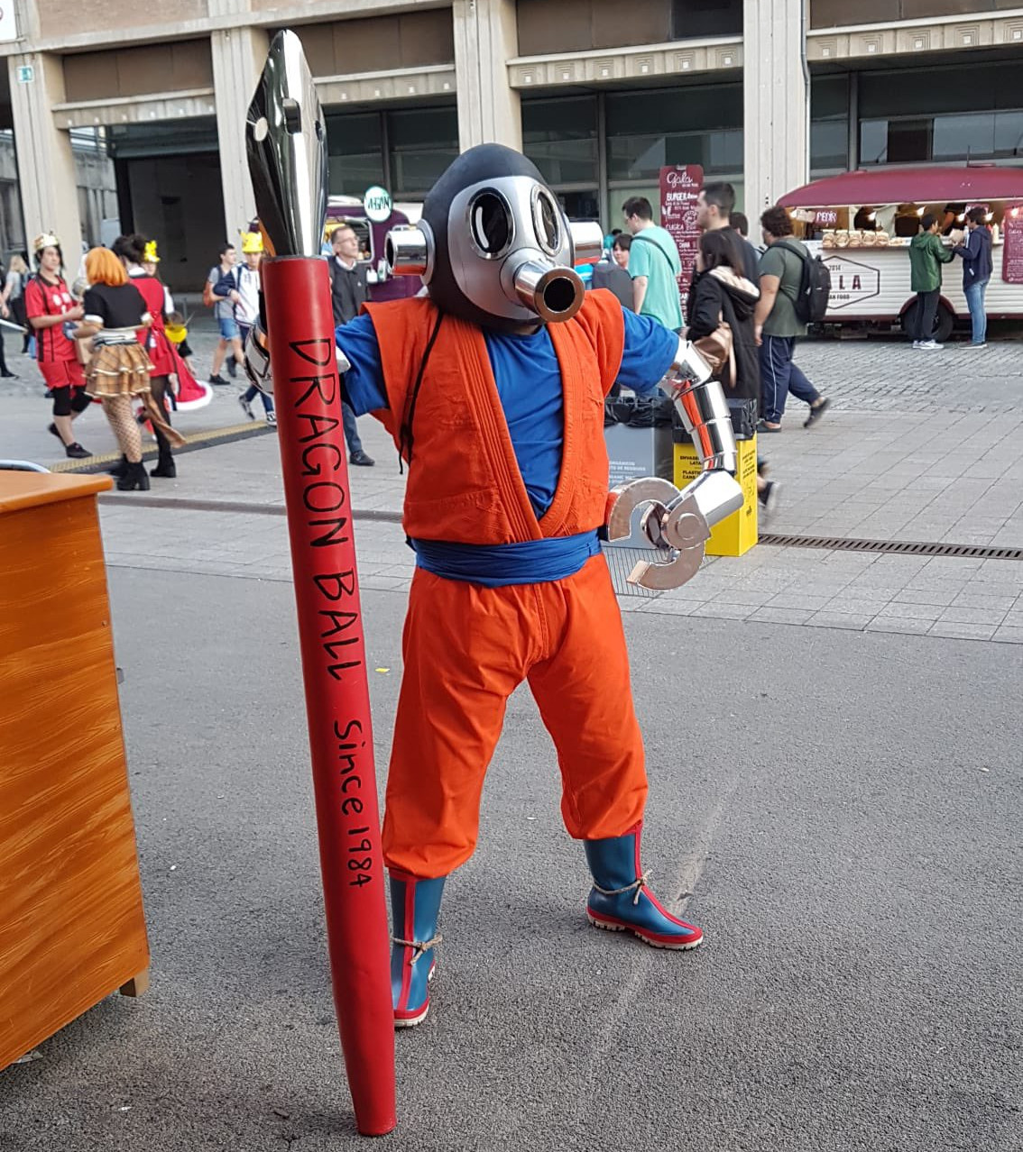 Cosplayer looking like Tori Bot with Goku's clothes. Article about a character Tori-Bot - an avatar of the Japanese mangaka master Akira Toriyama, author of Dr. Slump and Dragon Ball.