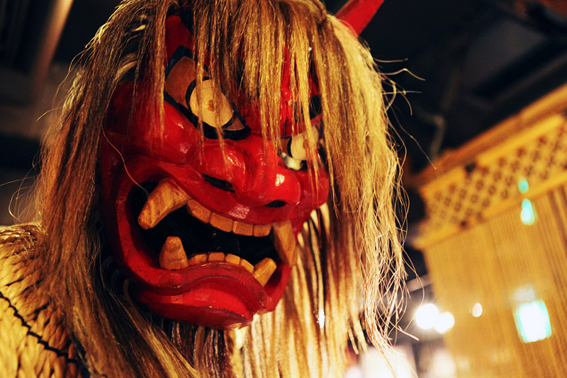 Red Namahage mask, Akita, Japan. Article about Japanese New Year's customs from remote snowy Akita - Namahage. Dark Namahage presence in New Year's day, their history, mythology behind it and role in modern Japan, manga, anime and video games.