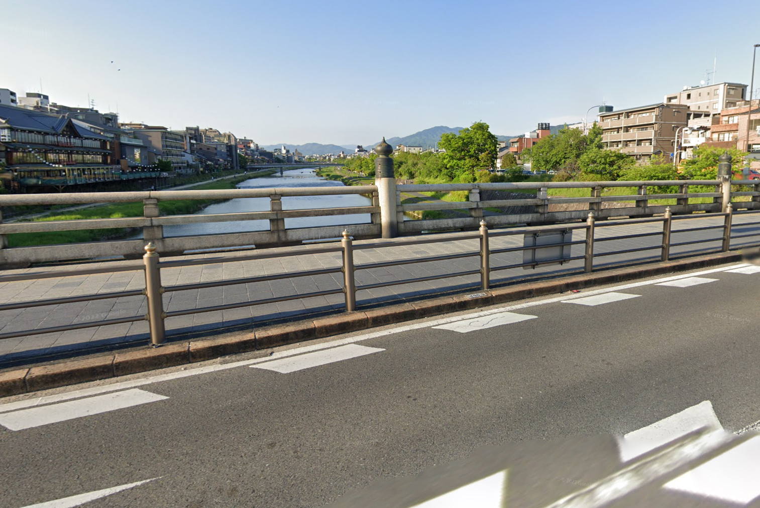 View from Gojo bridge from Kyoto, Japan - (google street view) The legendary fight on Gojo bridge between a young samurai Ushiwakamaru (later Yoshitsune Minamoto) and old monk-soldier (sohei) Benkei in Kamakura period. History and culture of Japan and its influence on manga and anime.