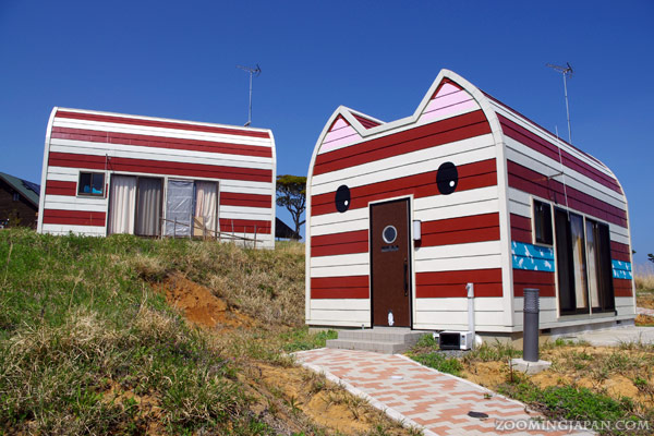 Cat-sjaped houses on Manga Island area on Tashirojima - Japanese island of cats. Article about cat island in Japan - Tashirojima. Island where cat population largely outnumbers human population. Has its own neko jinja cat shrine and even so called "Manga Island" with cat-shaped houses. Cats in Japan.