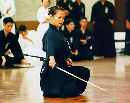 Japanese woman taining iaido - Japanese samurai's fighting style. Essay about the Japanese sword katana - the history, structure, meaning, symbolism of katana in samurai Japan (history of samurais and Japan)