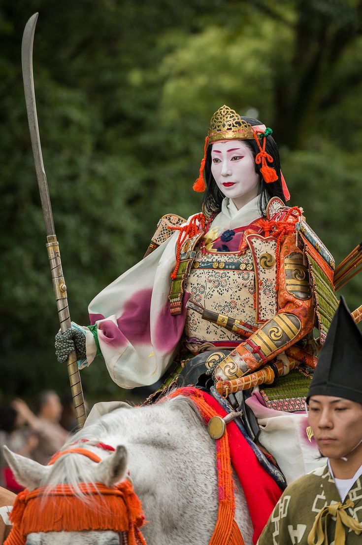 Various geishas play the role of Tomoe Gozen, female samurai during festivals of jidai matsuri in Japan. Essay about Tomoe Gozen - woman samurai (onna-bugeisha) from ancient Japan (Heian Period, 12 century). Female samurais in Japanese history. Documented by Heiko Monogatari.