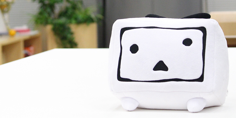 Japanese YouTube-like Nico Nico Douga's mascott from logo. In a pillow form. Article / essay about modern scene of Nico Nico Douga (Japanese YouTube-like video sharing community platform). Overview of main creators on Nico Nico Douga, such as Mirai akari, Kizuna AI, Hatsune Miku, Kazuo Umezu and more. Japan's manga and anime otaku world on Nico Nico Douga.