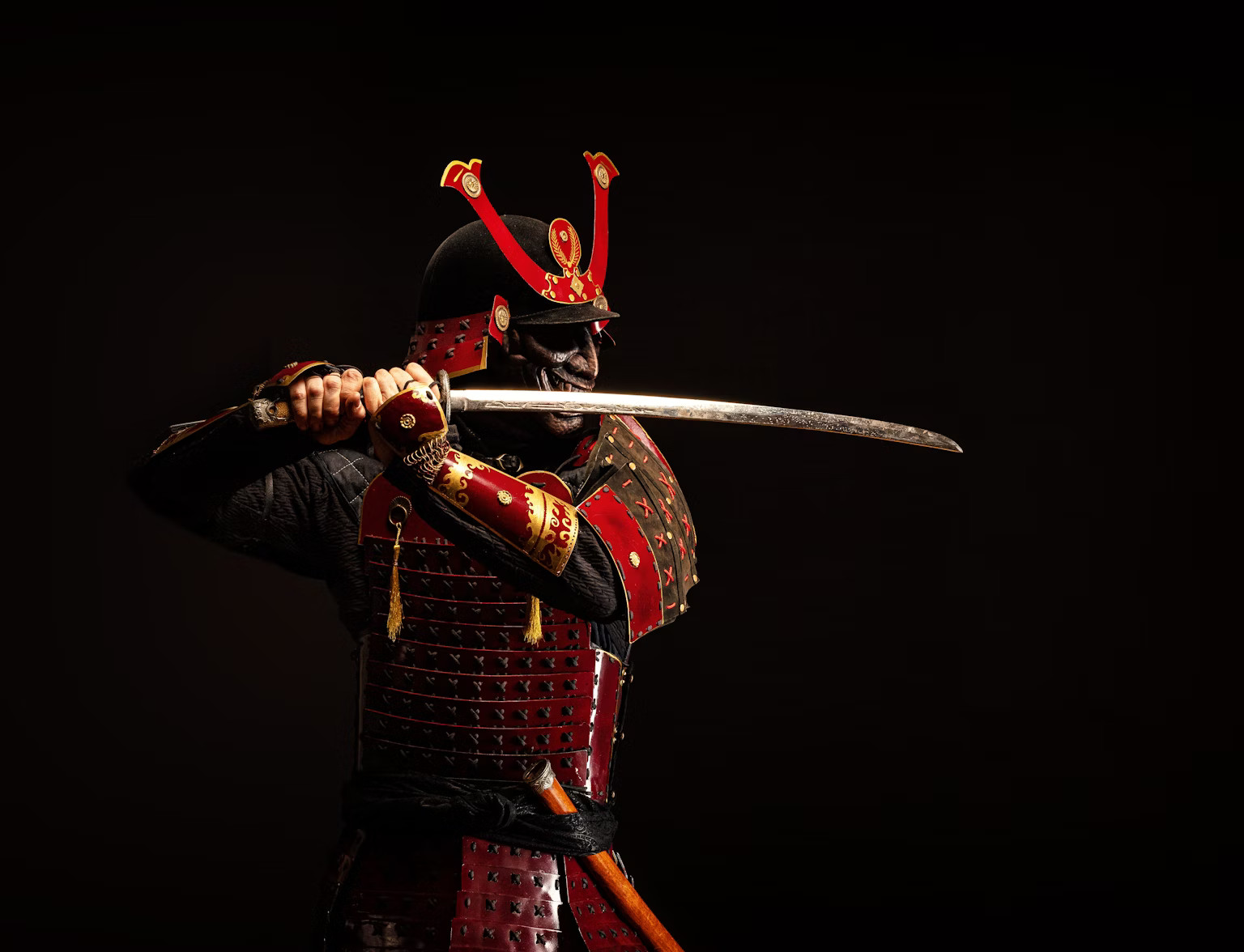 A red samurai in armor wnad with katana, Japan. Essay about the Japanese sword katana - the history, structure, meaning, symbolism of katana in samurai Japan (history of samurais and Japan)